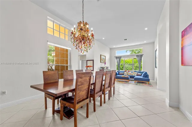 a view of a dining room with furniture and a chandelier