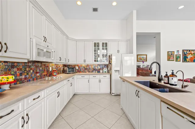 a kitchen with sink and cabinets