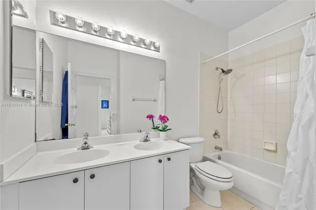 a bathroom with a sink vanity mirror and toilet
