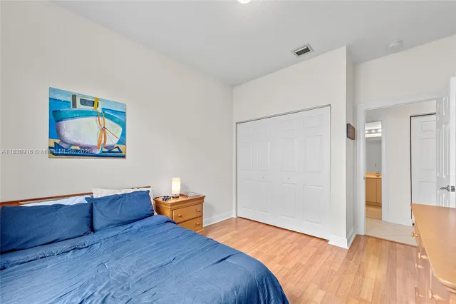 a bedroom with a bed and a painting on the wall