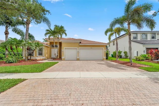 a front view of a house with a yard and a garage