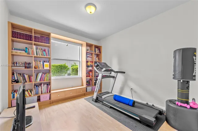 a room with gym equipment and a flat screen tv