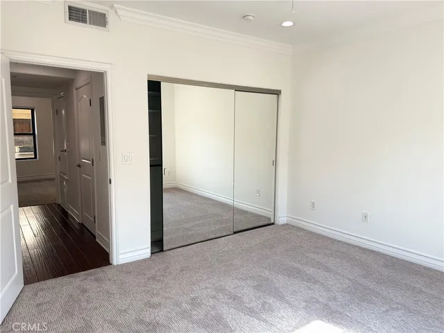 a front view of a building with trees