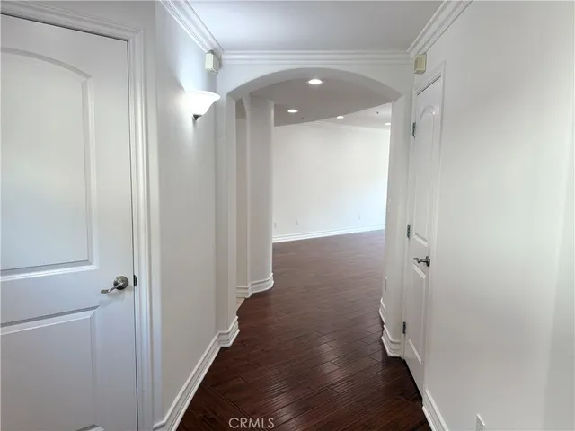 a view of a hallway with wooden floor