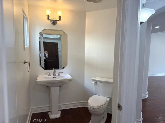 a bathroom with a sink toilet and a mirror
