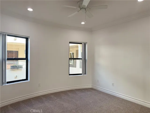 an empty room with windows and closet