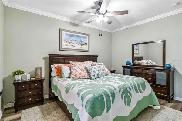 a bedroom with a bed and a lamp on dresser