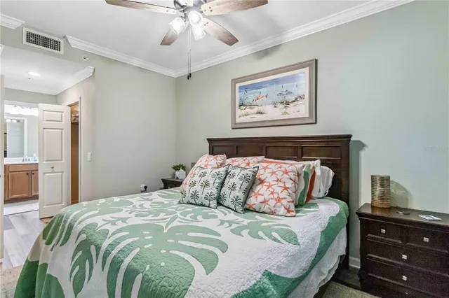 a bedroom with a large bed and a chandelier