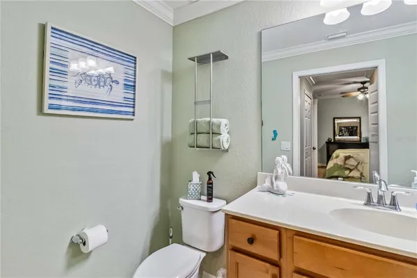 a bathroom with a granite countertop sink mirror and toilet