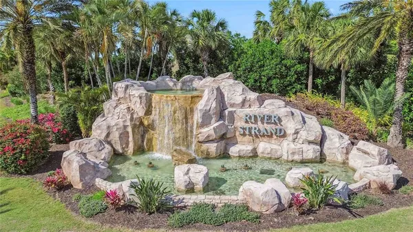 a view of a fountain with flower plants