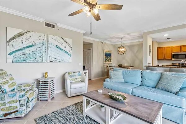 a living room with furniture and a chandelier
