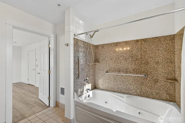 a bathroom with a bathtub and a shower