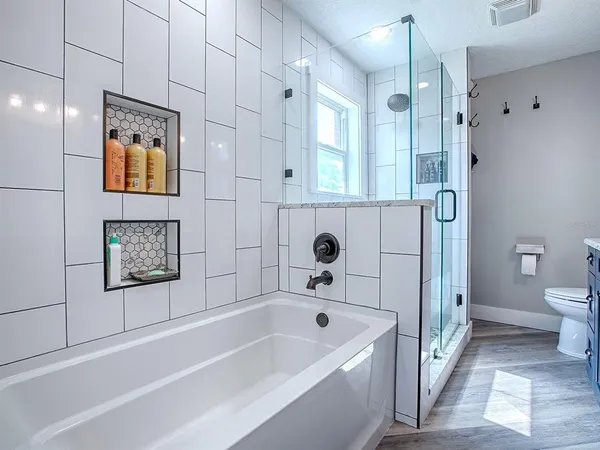a bathroom with a bathtub and a shower