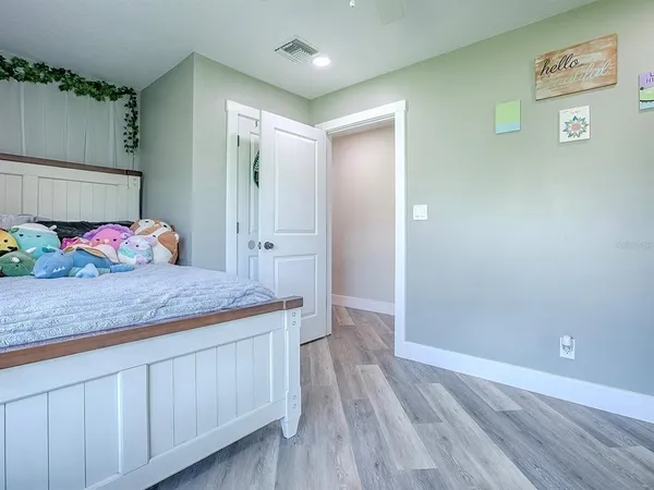 a bath room with a sink and wooden floor