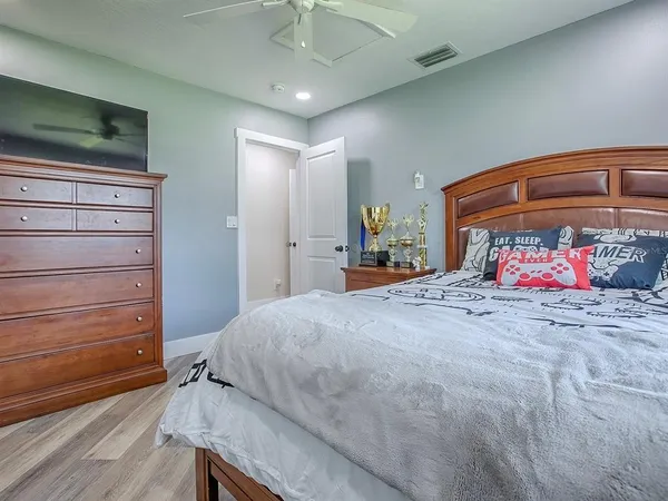 a bedroom with a bed and a dresser