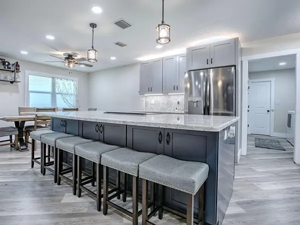 a large kitchen with a table and chairs