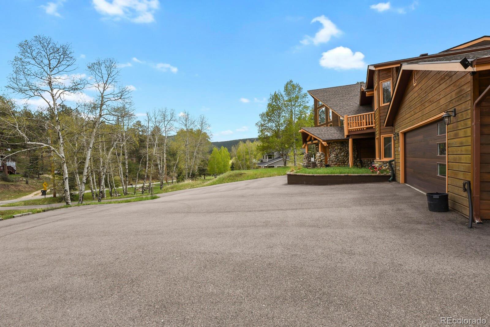 417 Witter Gulch Road Evergreen, CO 80439 - Photo 47 of 50 a view of a house with a street