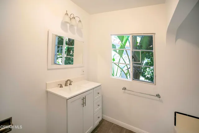 a bathroom with a sink and a window