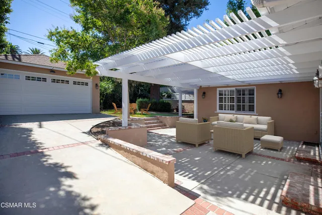 a view of a patio with couches and potted plants