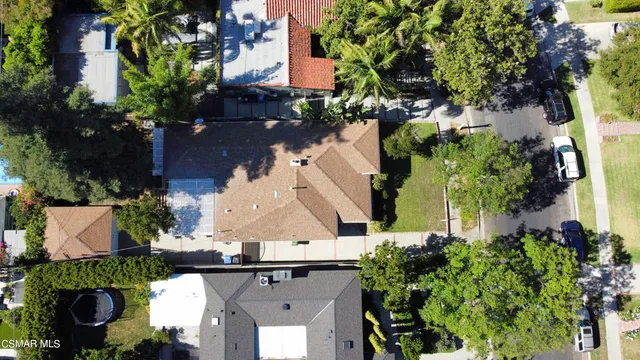 an aerial view of a house with a yard and garden