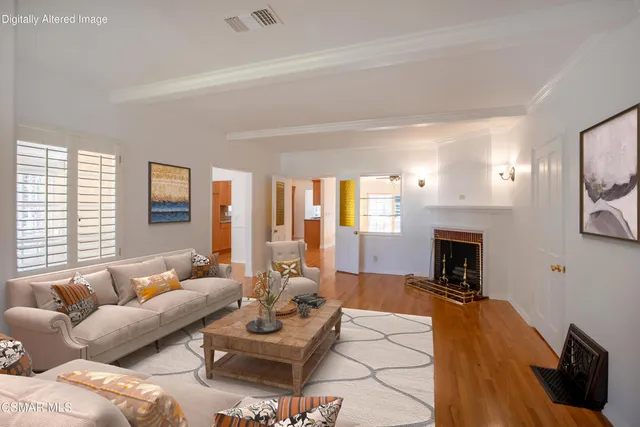 a living room with furniture fireplace and a large window