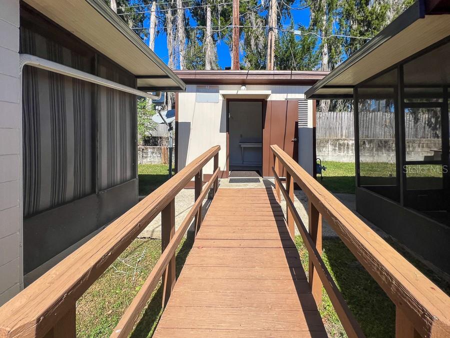 1406 Southwest 18th Place, Unit 11 Gainesville, FL 32608 - Photo 13 of 16 a view of balcony with wooden floor and iron stairs