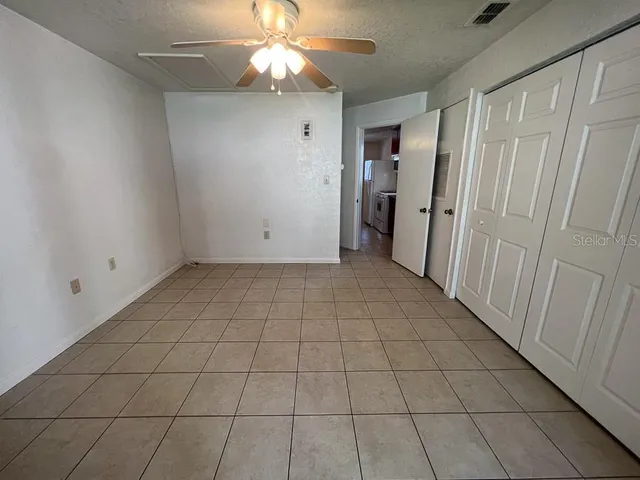 a view of a porch with wooden floor and a stairs
