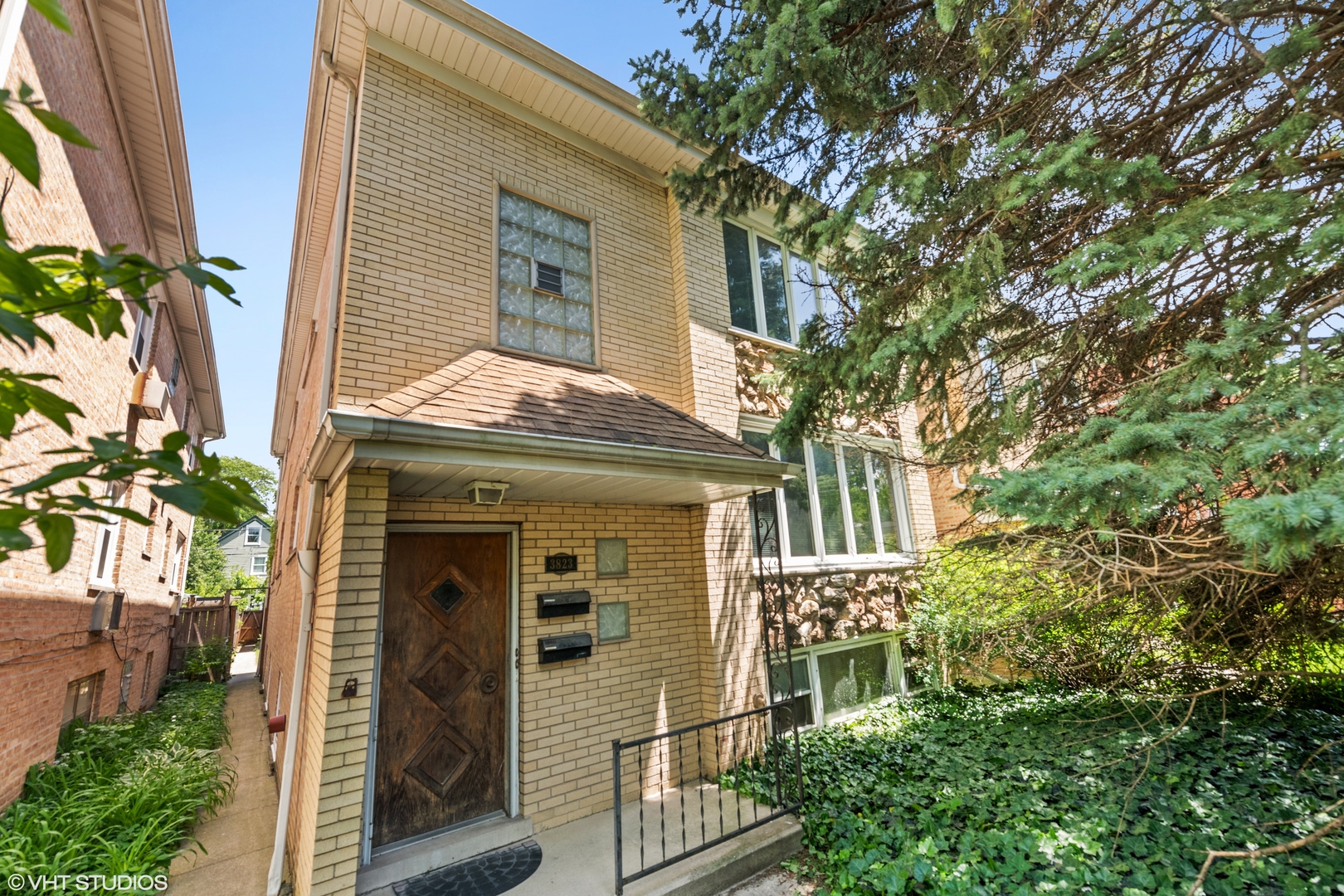 Undisclosed Address Chicago, IL 60641 - Photo 2 of 19 a front view of a house with a garden