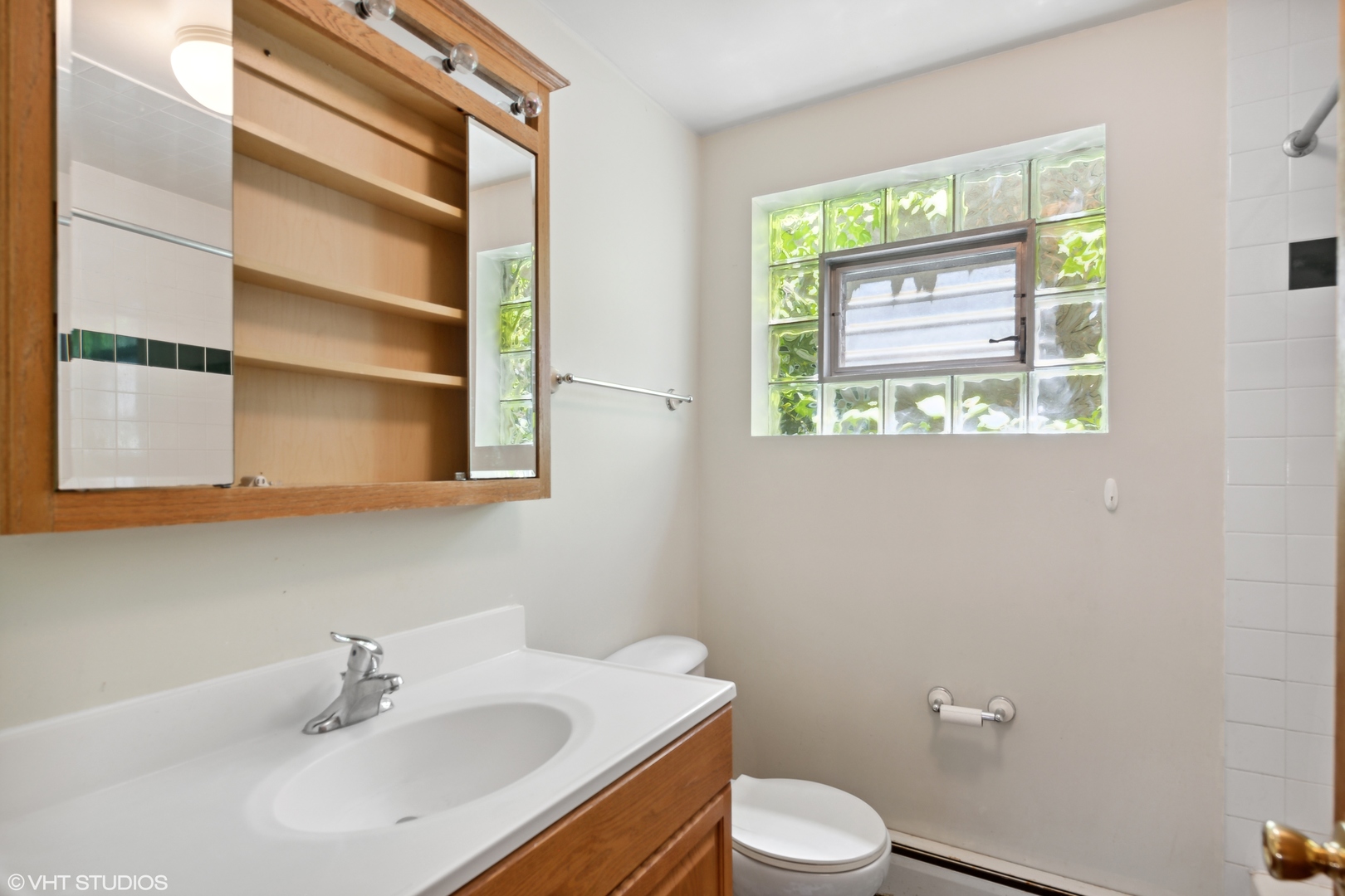 Undisclosed Address Chicago, IL 60641 - Photo 6 of 19 a bathroom with a sink toilet and window