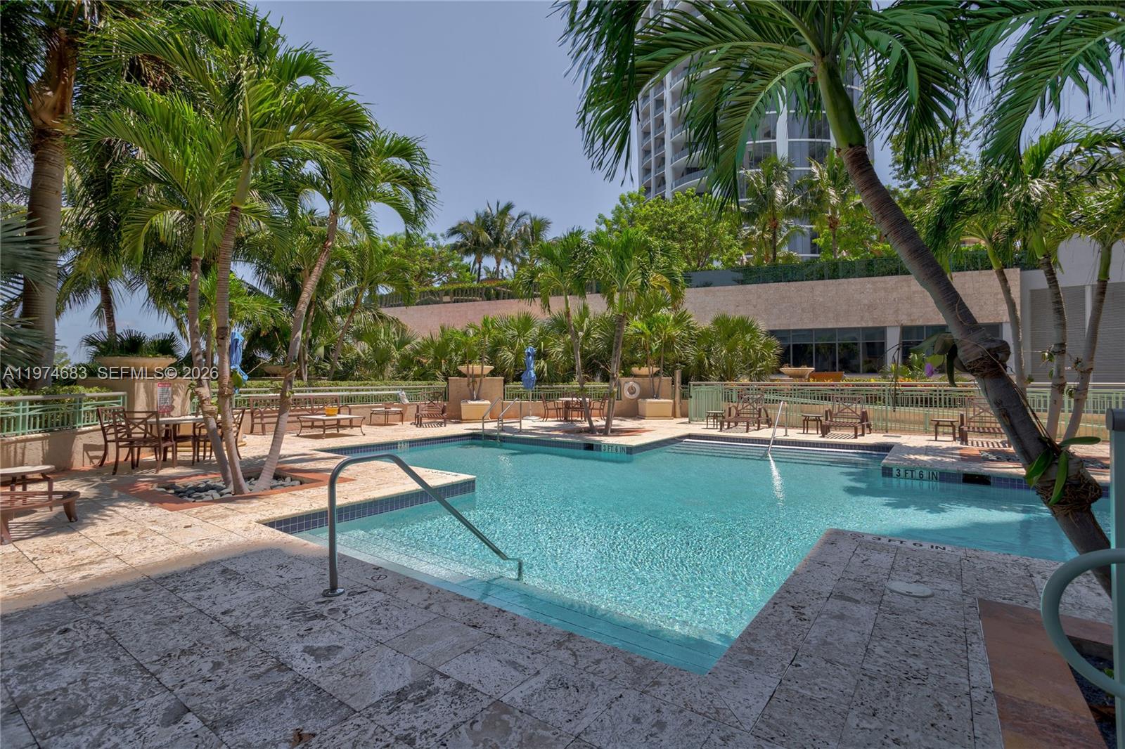 3400 Southwest 27th Avenue, Unit 906 Miami, FL 33133 - Photo 24 of 35 a swimming pool with outdoor seating and yard