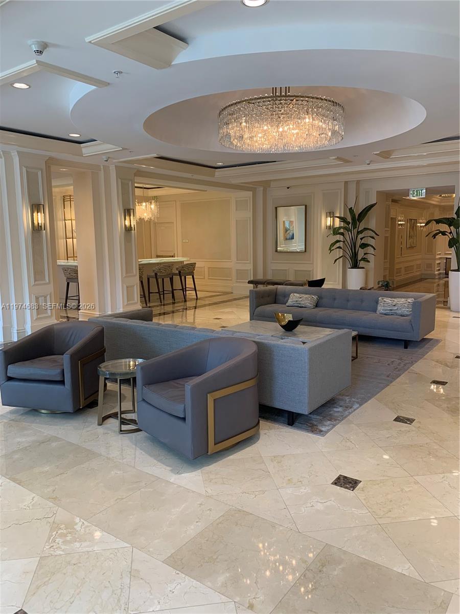 3400 Southwest 27th Avenue, Unit 906 Miami, FL 33133 - Photo 32 of 35 a living room with furniture and a large window