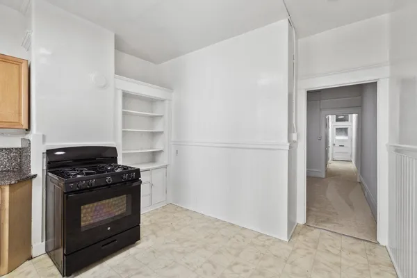 a kitchen with a stove and a refrigerator