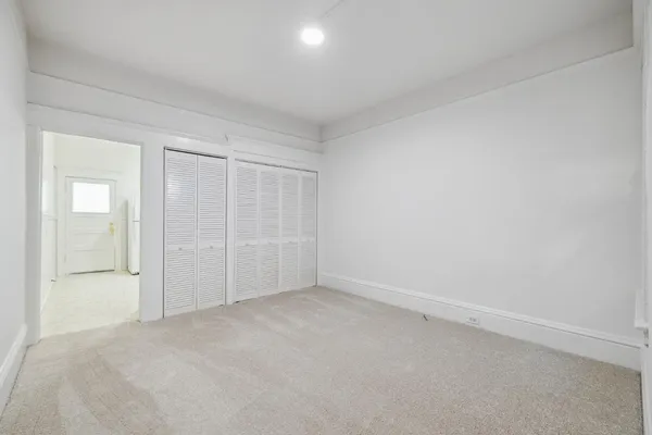 an empty room with a kitchen