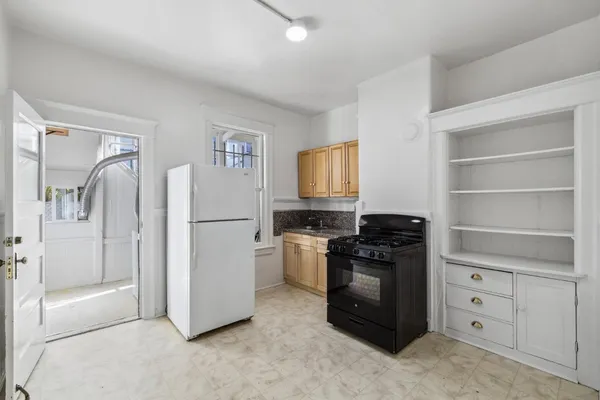 a kitchen with stainless steel appliances granite countertop a stove and a microwave oven