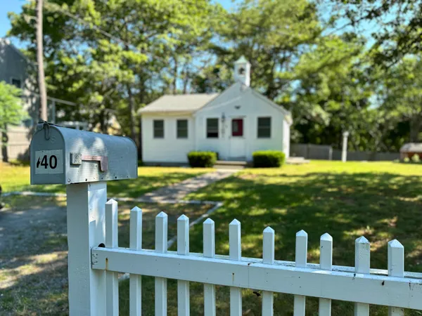 a front view of house with yard and trees