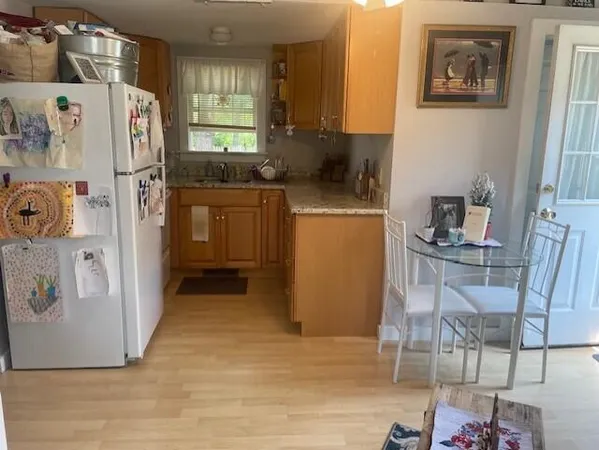 a kitchen with a refrigerator and cabinets
