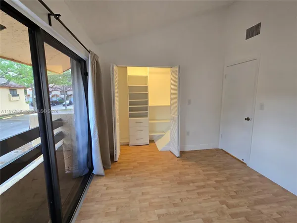 a view of entryway with wooden floor and windows