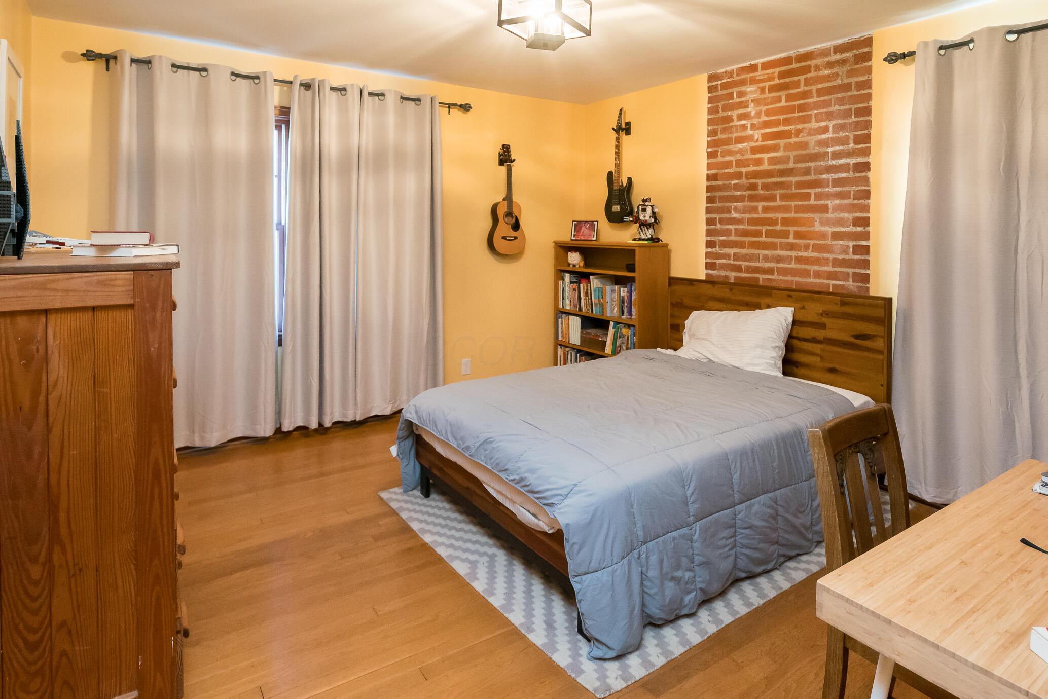 459 Tibet Road Columbus, OH 43202 - Photo 27 of 42 Bedroom 3, exposed brick, oak flooring