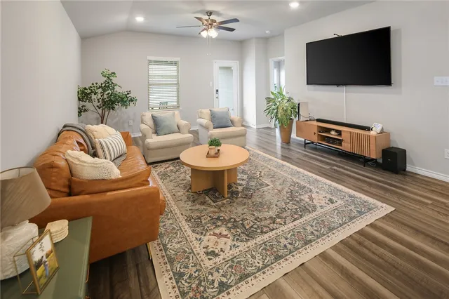 a living room with furniture and a flat screen tv