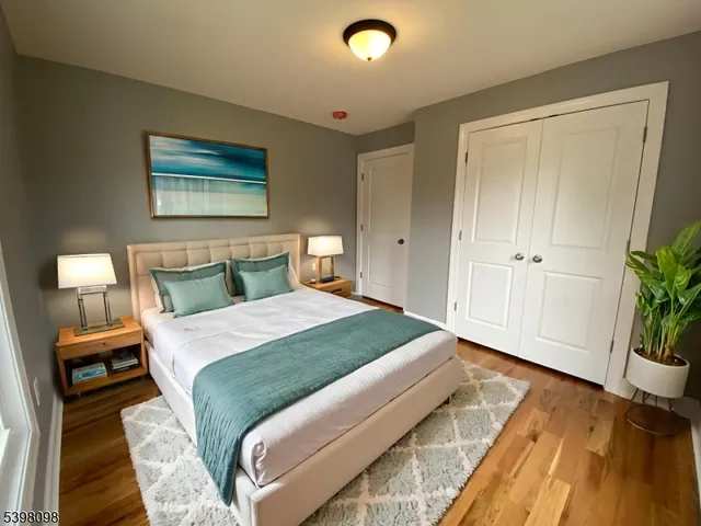 a bedroom with a bed and a potted plant