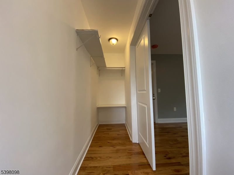 59 West Stewart Street Washington, NJ 07882 - Photo 15 of 22 a view of a hallway with wooden floor and staircase