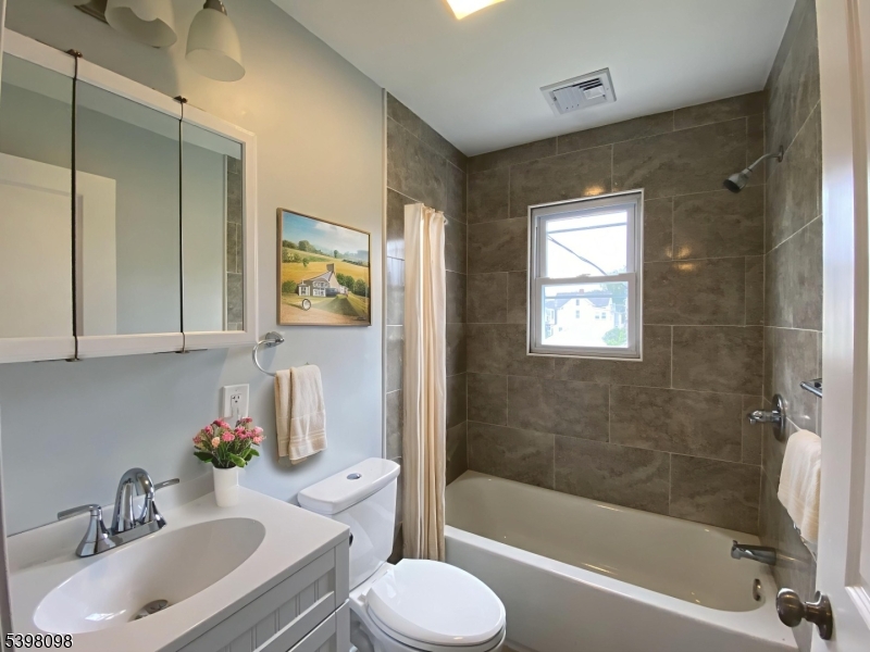 59 West Stewart Street Washington, NJ 07882 - Photo 16 of 22 a bathroom with a sink toilet and shower