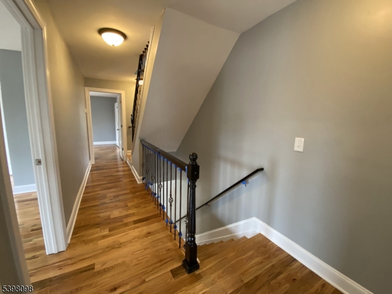 59 West Stewart Street Washington, NJ 07882 - Photo 17 of 22 a view of a hallway with wooden floor and staircase