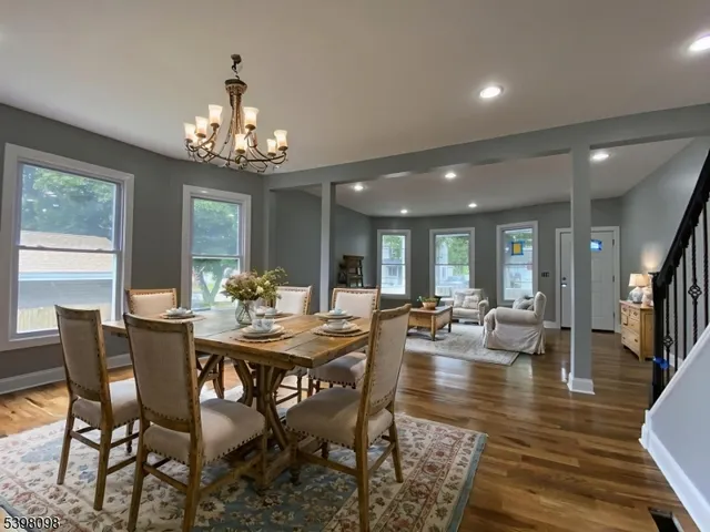 a view of a dining room with furniture wooden floor and chandelier