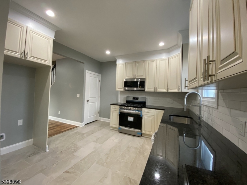 59 West Stewart Street Washington, NJ 07882 - Photo 7 of 22 a kitchen with stainless steel appliances granite countertop a stove a sink and a refrigerator