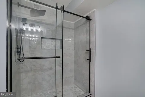 a bathroom with a glass shower door