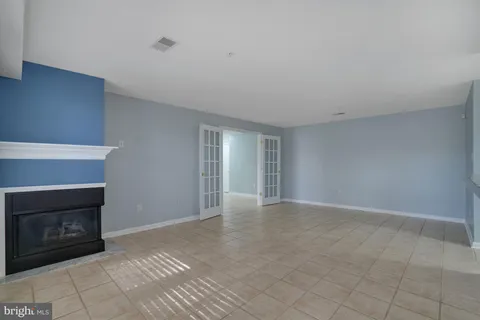 a view of an empty room with kitchen natural light