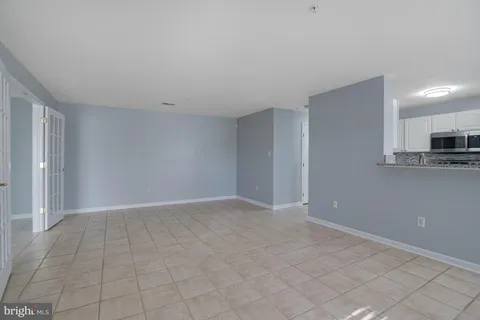 a view of an empty room with a fireplace and a window