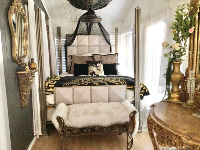 a bedroom with a bed and a chandelier