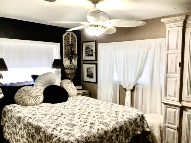 a view of a livingroom with wooden floor and a large window